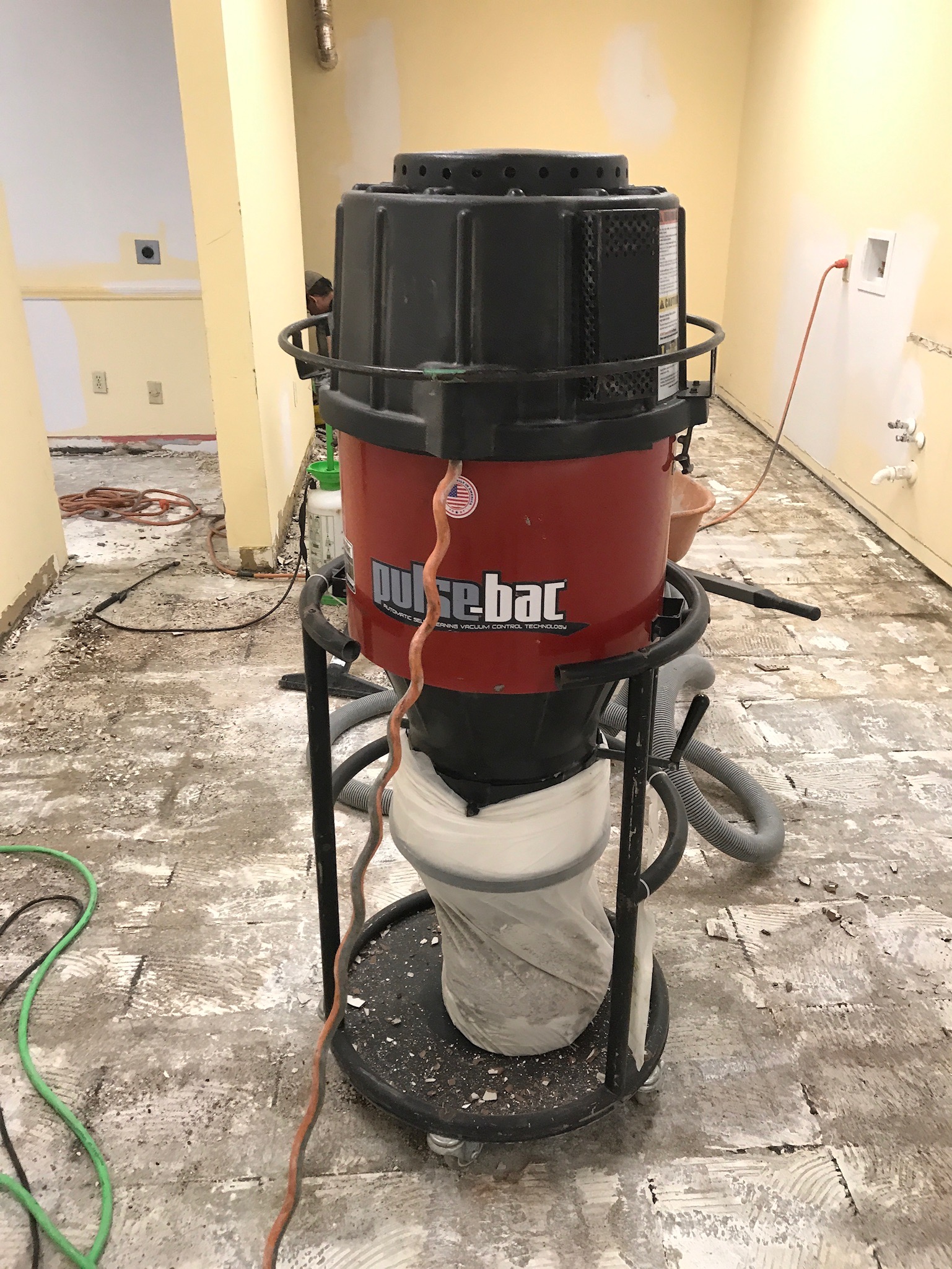 Image of our industrial vacuum suctioning dust from tile floor removal