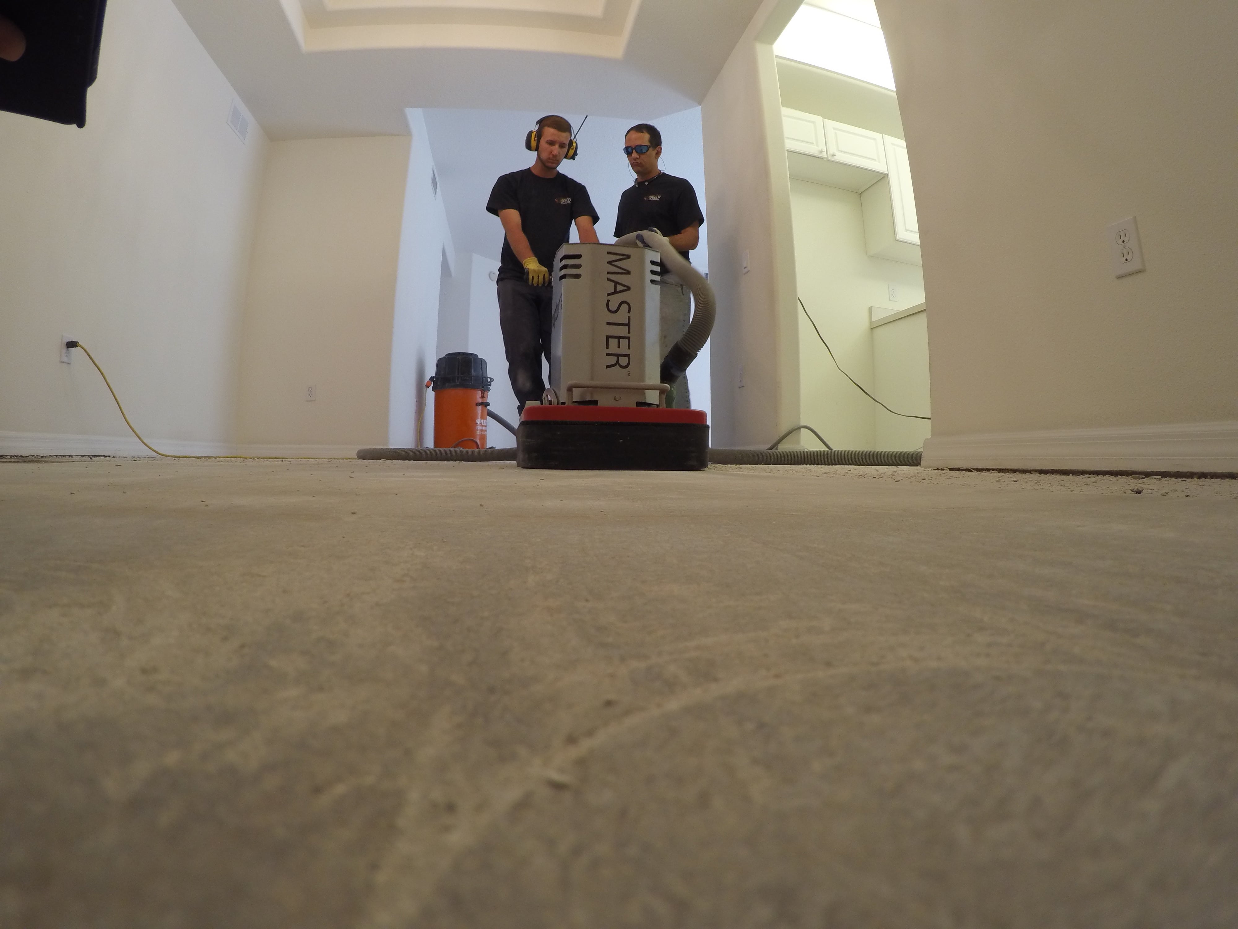 Image of crew working to clean a smooth concrete sub-floor