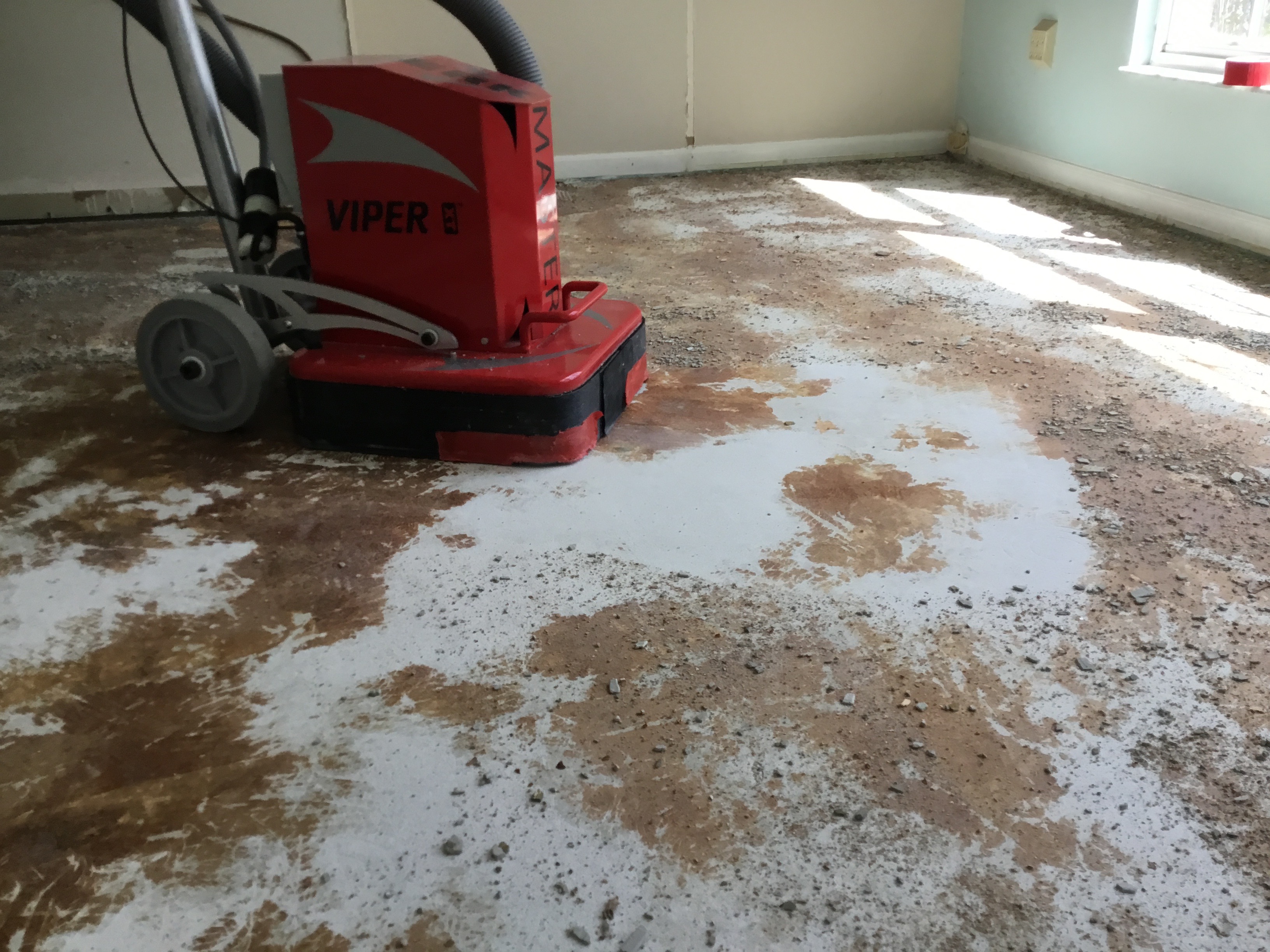 Image of wood floor glue removal from concrete subfloor